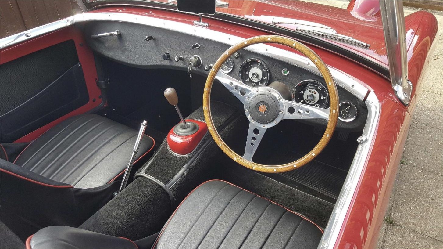Restored roadster cockpit with wood-rimmed steering wheel